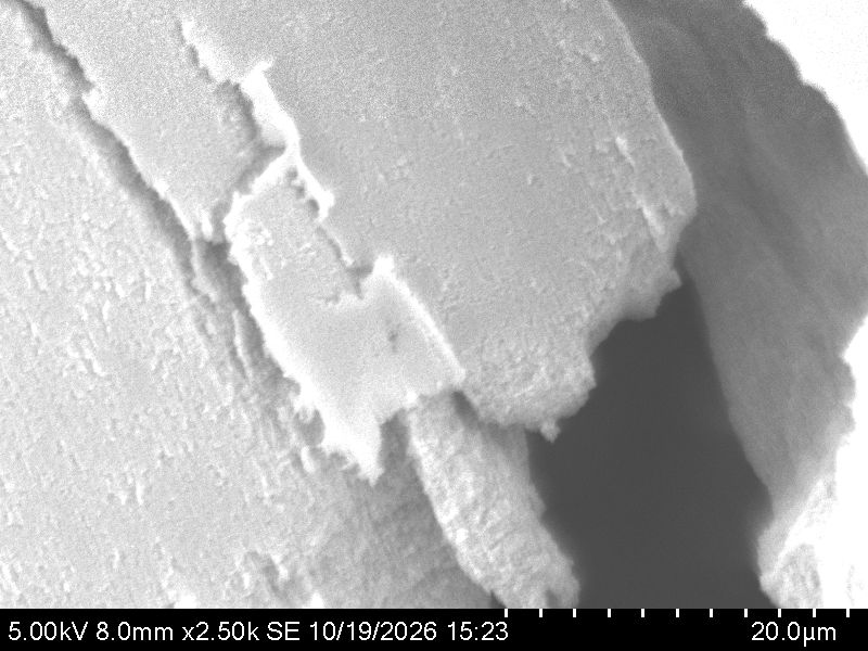 SEM image of TiO2 surface texture and a crack edge at 2500 times magnification